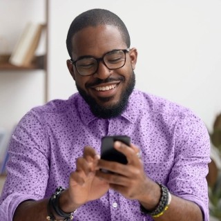 Image of man on phone smiling